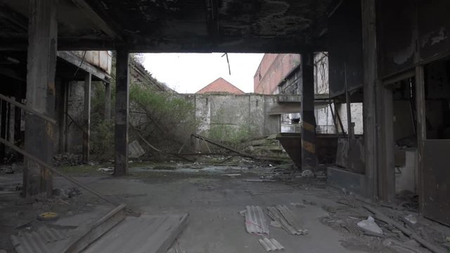 Old derelict industrial brick warehouse with exposed roof girders.