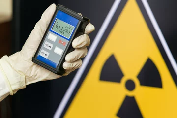 Foto op Aluminium Radiation supervisor in glove with geiger counter checks the level of radiation © filin174