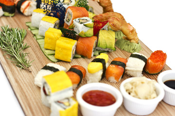 Japanese food - Sushi, sashimi, rolls on a wooden board. Isolated