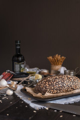 Oat bread with butter, garlic, salt, oil on a brown table for breakfast