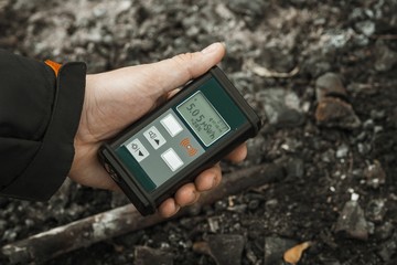 Man checking radiation with geiger counter