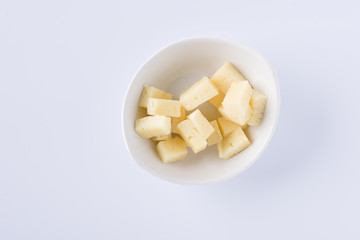 white bowl with pieces of tasty pecorino cheese on white background