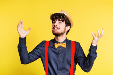 Studio portrait of a young man on a yellow background.