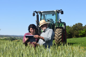 couple of farmers looking at a field