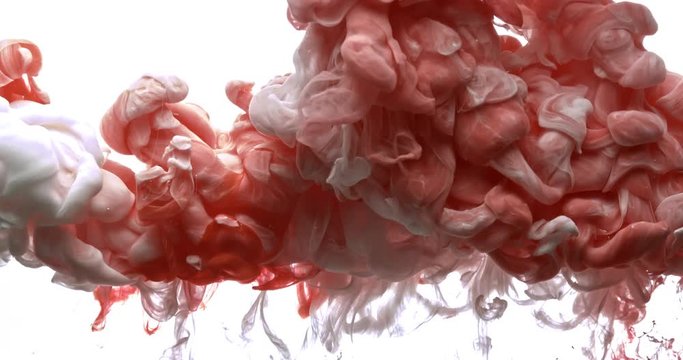 Red and white ink spraying in water on white background shooting with 4k high speed camera.