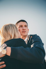 Close up of a cute young beautiful couple, man defending and hugging his girlfriend looking scared somewhere