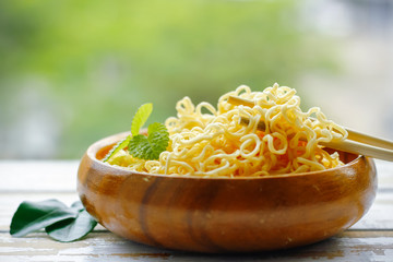 Instant Noodles Put on Wooden Table on green background.
