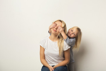 Happy mother and daughter embracing at studio