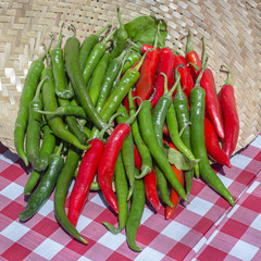 Organic, fresh, raw green and red peppers for sale at a local farmers market in Bali, Indonesia. Close up