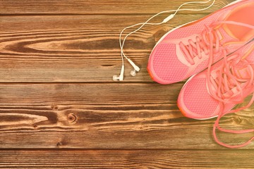 Pink sneakers on wooden texture