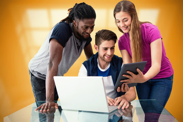 Creative team looking at digital tablet against room with large window showing city