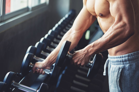 Muscular Man Taking Weights In Gym