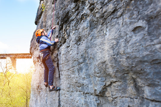 Kid Rock Climber Climbs The Cliff.