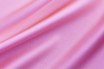 Fototapeta na wymiar pink viscose fabric with large diagonal folds