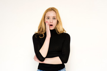 Portrait of a beautiful blonde girl on a white background showing surprise and delight.