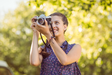 Pretty hipster taking a photo