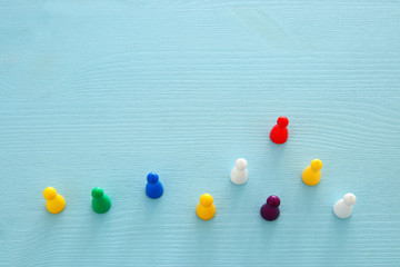 image of colorful game figures over wooden table ,human resources and management concept.