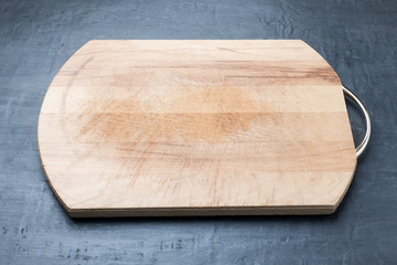 Rustic wood cutting Board on dark background blank text space, design element