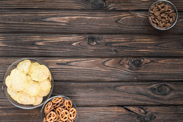 chips, crackers, snacks on the background of a wooden table. beer snacks.