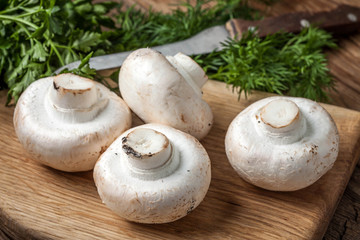 Fresh mushrooms on cutting board.