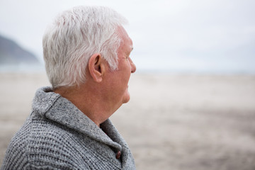 Thoughtful senior man standing