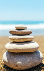 Fototapeta na wymiar Stack of zen stones on the beach near sea