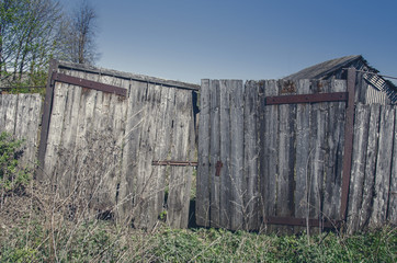 Fototapeta na wymiar Gray old wooden gate, fence.