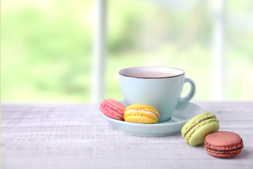 Coffee and macaroons on wooden empty space background.