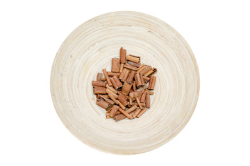 Cinnamon sticks on a plate isolated white background.