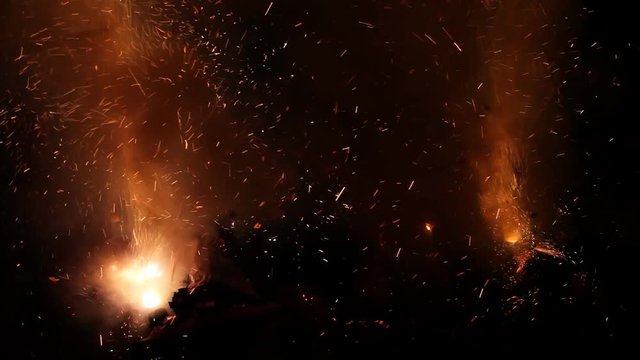 Fireworks packs on ground, explosions and smoke