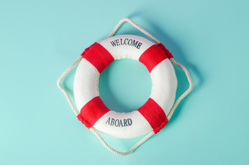 Small red and white lifebuoy on blue background