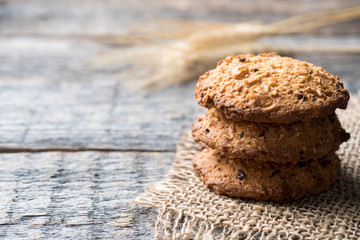 Oatmeal cereal cookies on napkin burlap wood table