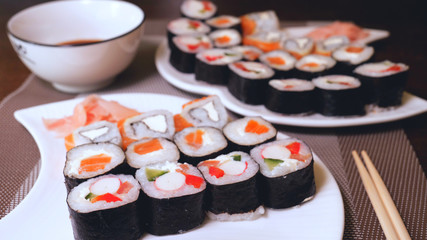 Sushi bar or restaurant, fresh sushi, Philadelphia cheese, crab sticks, salmon, rice, ginger, soy, macro.