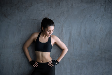 Close up asian beautiful sportswoman wear sport bra on wall of gym,Thailand love health,Slim woman...
