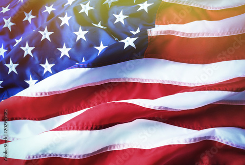 American flag background. Brightly lit American flag. Sunlight, sunflare.