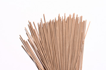 Beautiful buckwheat noodles, raw, not cooked, on white background