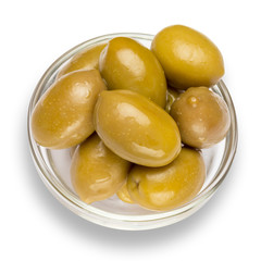 green olives isolated in glass bowl on white background