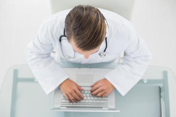 Overhead view of a male doctor using laptop