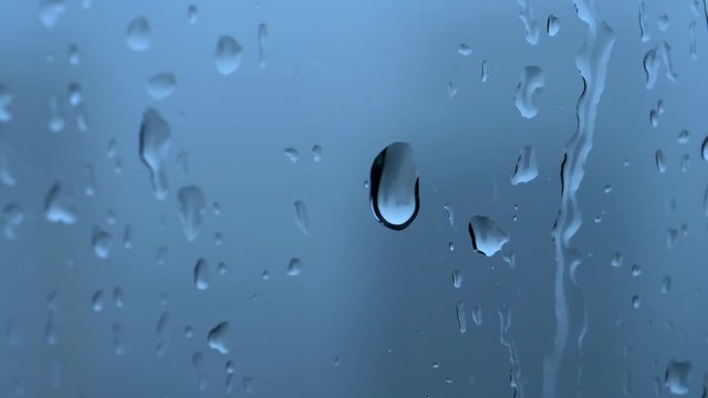 Water drops on window glass in rainy day
