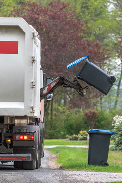 Municipal waste disposal. With a special car garbage truck, the garbage from the garbage bin is loaded into the car. Concept: Waste disposal and cleanliness