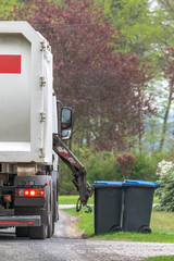 Municipal waste disposal. With a special car garbage truck, the garbage from the garbage bin is...