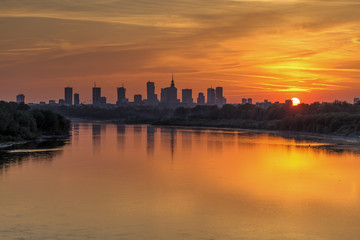Evening panorama of Warsaw skyline over Vistula river at sunset, Poland