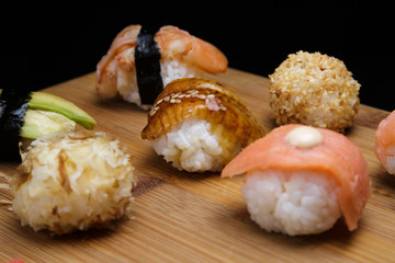 Sushi Set sashimi and rolls served on wooden desk