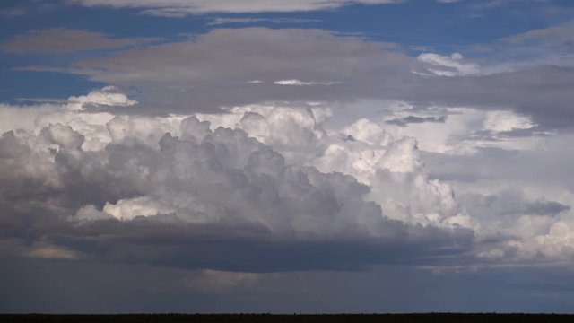 Billowing cumulus flowing across frame, time lapse