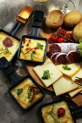 Delicious traditional Swiss melted raclette cheese on diced boiled or baked potato.