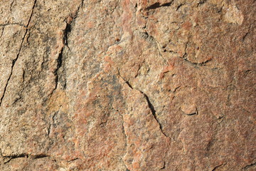 Natural stone granite texture, granite pattern. Stone background of mottled granite igneous rock used for kitchen worktops etc. Surface of the marble with brown tint. Minimalism