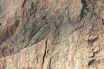 Natural stone granite texture, granite pattern. Stone background of mottled granite igneous rock used for kitchen worktops etc. Surface of the marble with brown tint. Minimalism