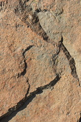 Natural stone granite texture, granite pattern. Stone background of mottled granite igneous rock used for kitchen worktops etc. Surface of the marble with brown tint. Minimalism