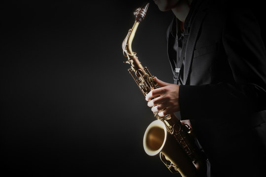 Saxophone player. Saxophonist hands playing saxophone