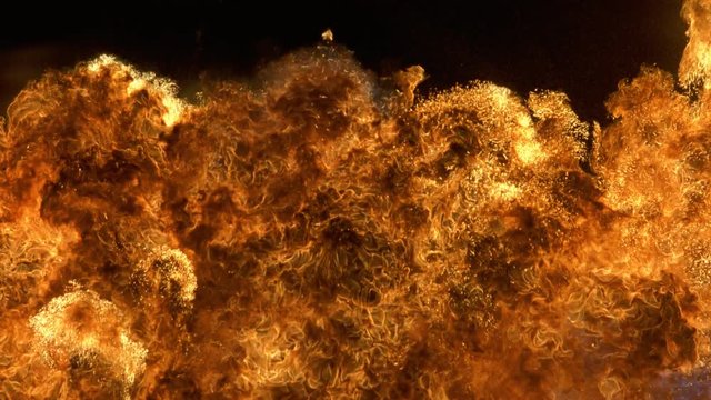 Explosion of flames expanding to fill frame before rising out of view